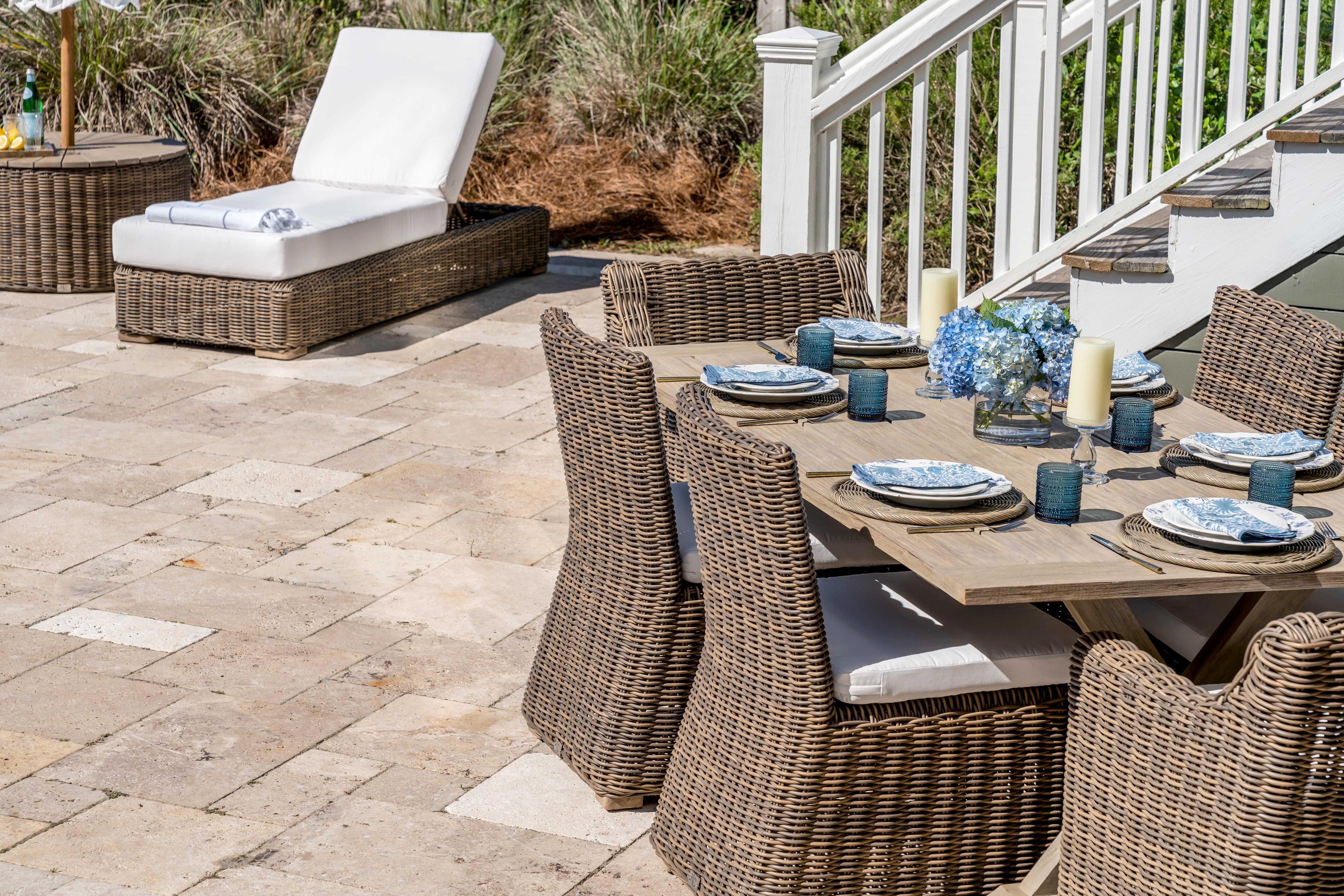 Outdoor Grey Teak Trestle Dining Table with wicker chairs