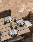 Grey teak wood dining table with wicker patio dining chairs